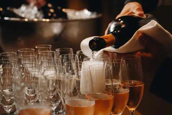 Pouring Champagne into glasses on the bar